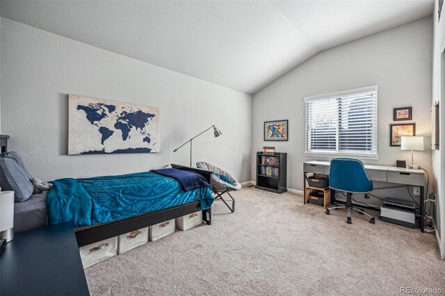 carpeted bedroom featuring lofted ceiling and baseboards