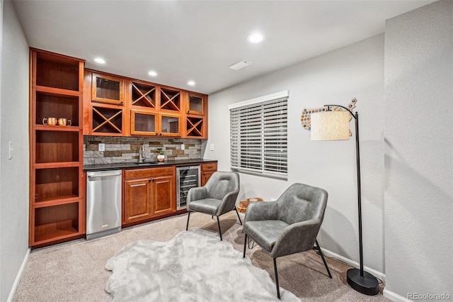 bar with a dry bar, light colored carpet, wine cooler, backsplash, and a sink