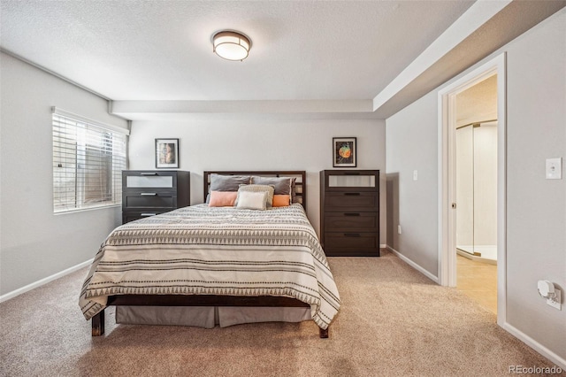 carpeted bedroom featuring a textured ceiling and baseboards