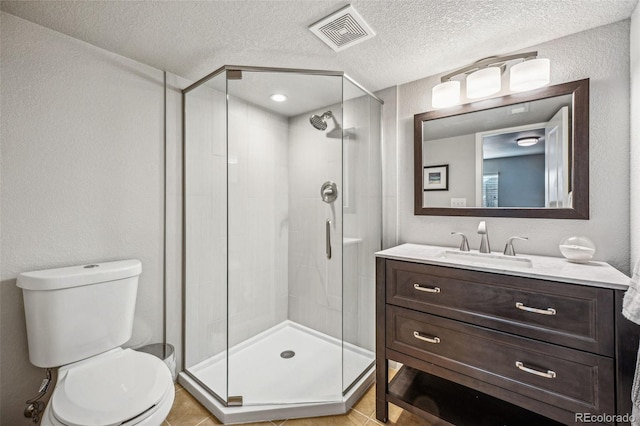 full bathroom with a stall shower, visible vents, toilet, a textured ceiling, and vanity