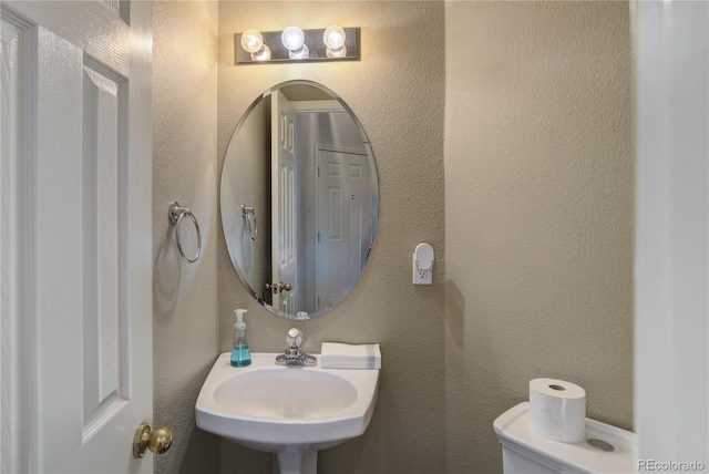 bathroom featuring sink and toilet