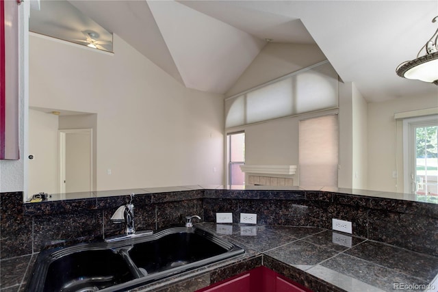 kitchen with vaulted ceiling, ceiling fan, and sink