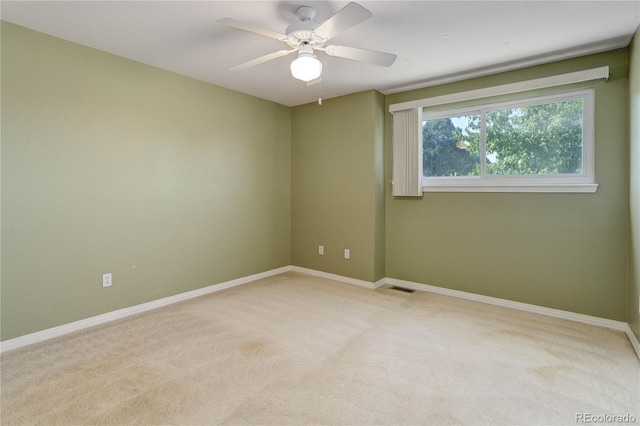 carpeted empty room with ceiling fan