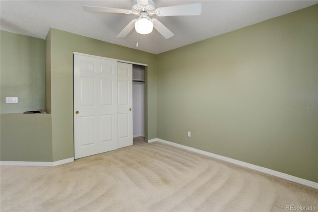 unfurnished bedroom with light carpet, a closet, and ceiling fan