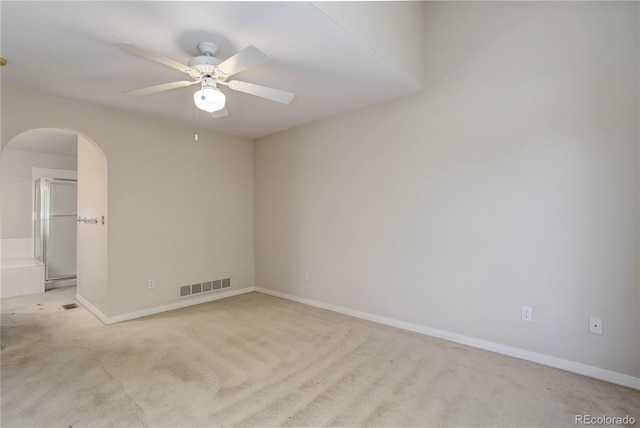 carpeted spare room with ceiling fan