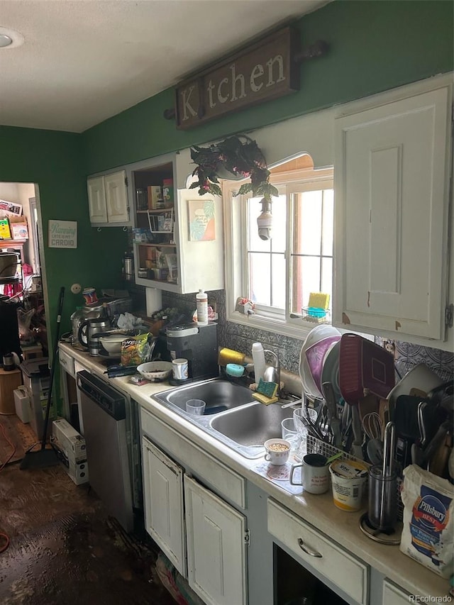 kitchen with sink, white cabinets, and stainless steel dishwasher