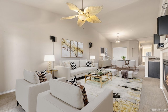 2405 Calais Dr Unit 18A, Longmont, CO 80504 - living room featuring light carpet, lofted ceiling, ceiling fan, a fireplace, and baseboards