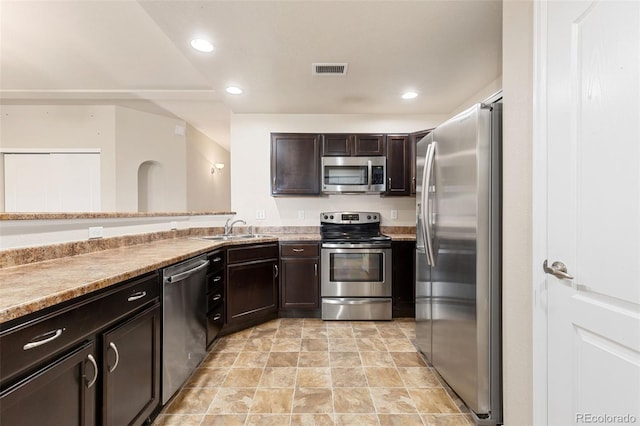 2405 Calais Dr Unit 18A, Longmont, CO 80504 - kitchen featuring appliances with stainless steel finishes, dark brown cabinets, a sink, and recessed lighting