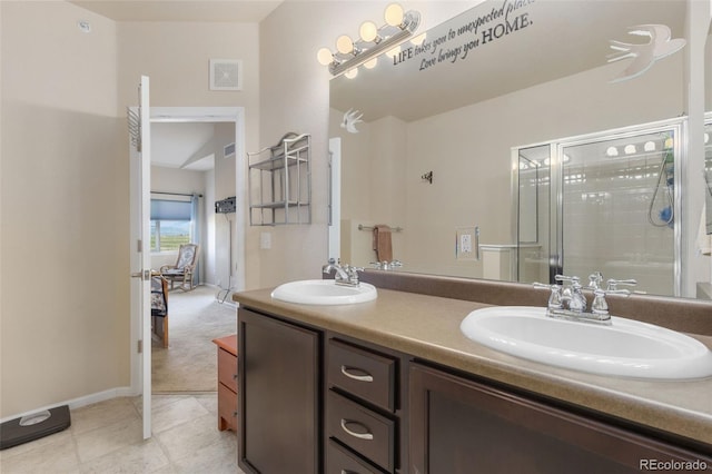 2405 Calais Dr Unit 18A, Longmont, CO 80504 - full bathroom featuring a shower with shower door, double vanity, tile patterned flooring, and baseboards
