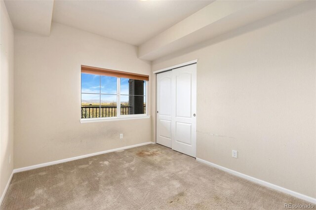 2405 Calais Dr Unit 18A, Longmont, CO 80504 - unfurnished bedroom featuring carpet flooring, baseboards, and a closet