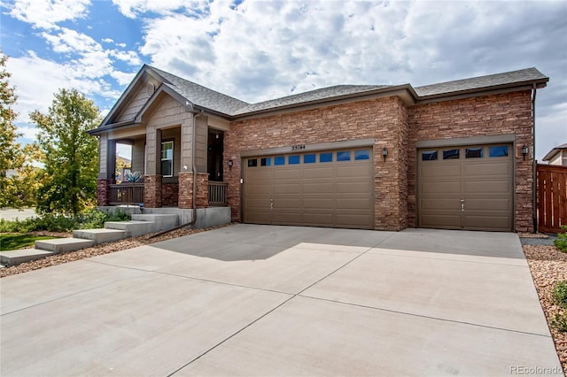 view of front of property featuring a garage, concrete driveway, roof with shingles, and fence