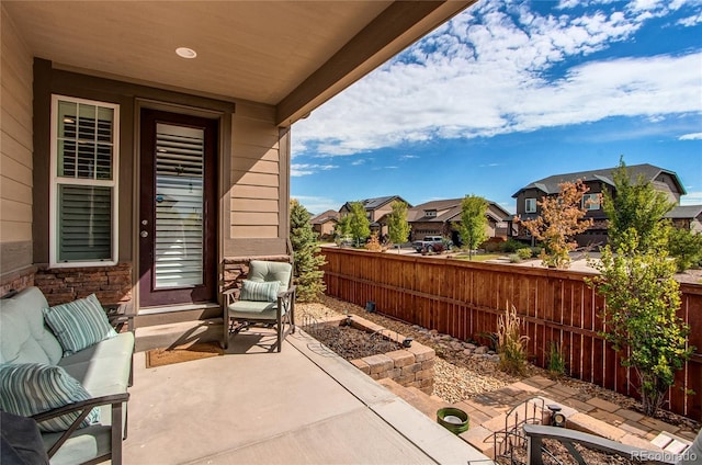 view of patio / terrace with fence and a residential view