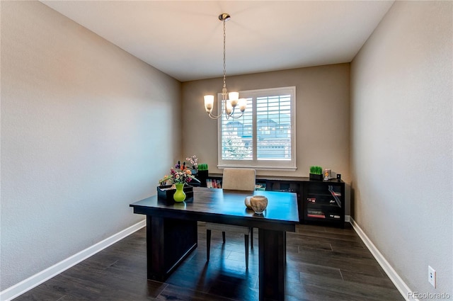 office space with baseboards, dark wood-type flooring, and a notable chandelier