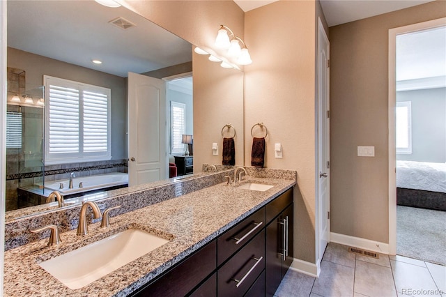 ensuite bathroom with connected bathroom, visible vents, a sink, and tile patterned floors