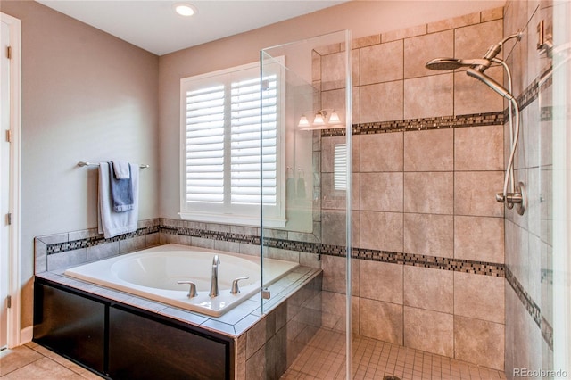 bathroom with a garden tub, a shower stall, and tile patterned floors