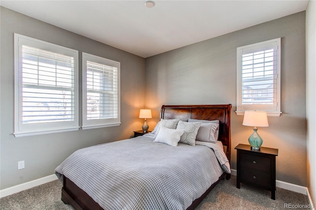 carpeted bedroom with multiple windows and baseboards