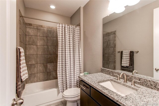 full bath featuring tile patterned flooring, vanity, toilet, and shower / bath combo with shower curtain