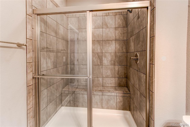 full bath with a shower stall