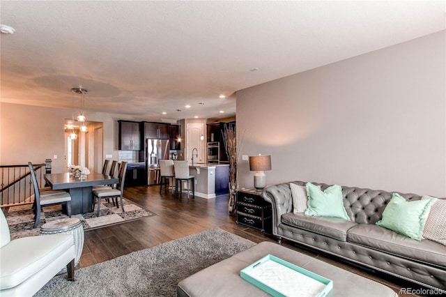 living room featuring recessed lighting and dark wood finished floors