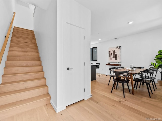 1601 Park Ave Unit 212, Denver, CO 80218 - staircase featuring baseboards, wood finished floors, and recessed lighting