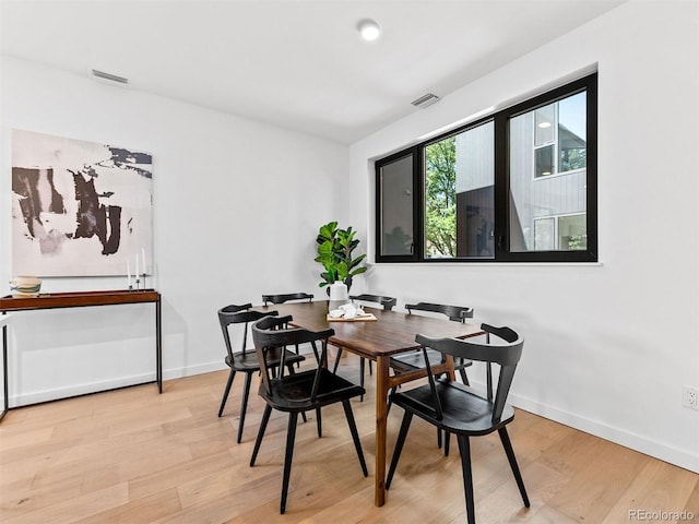 1601 Park Ave Unit 212, Denver, CO 80218 - dining area with visible vents, light wood-style flooring, and baseboards