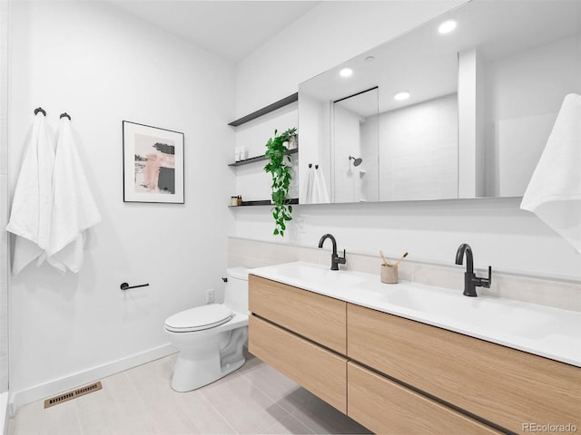 1601 Park Ave Unit 212, Denver, CO 80218 - bathroom with toilet, a sink, visible vents, double vanity, and walk in shower