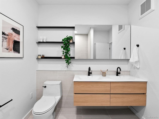 1601 Park Ave Unit 212, Denver, CO 80218 - full bathroom with toilet, double vanity, a sink, and visible vents