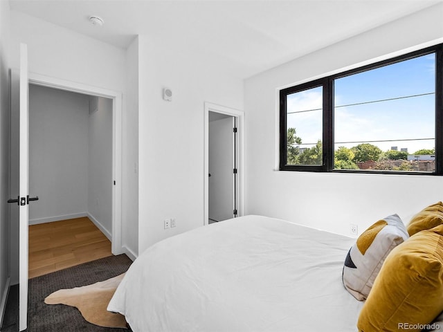 1601 Park Ave Unit 212, Denver, CO 80218 - bedroom with baseboards and wood finished floors