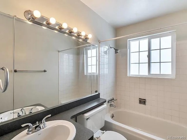9135 W Maplewood Ave, Littleton, CO 80123 - bathroom featuring a sink, bathing tub / shower combination, and toilet