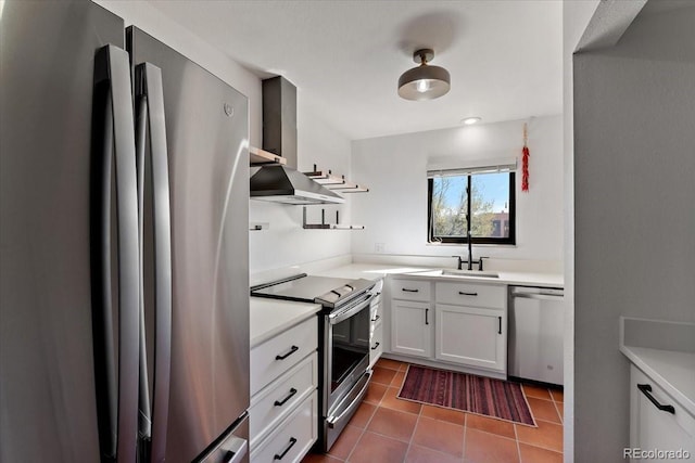 2979 Mesa Rd Unit D, Colorado Springs, CO 80904 - kitchen with stainless steel appliances, wall chimney exhaust hood, a sink, light countertops, and dark tile patterned floors