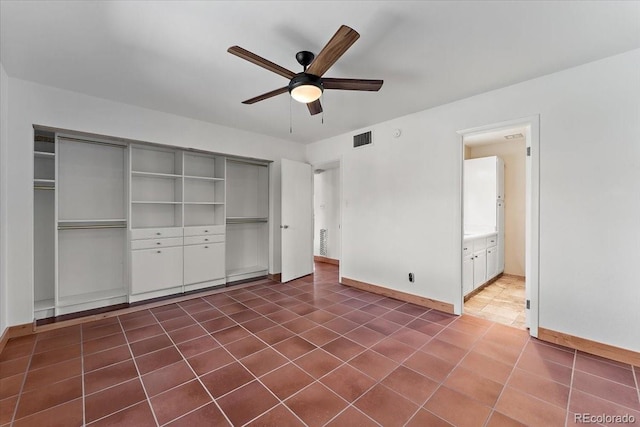 2979 Mesa Rd Unit D, Colorado Springs, CO 80904 - unfurnished bedroom featuring a closet, baseboards, a ceiling fan, and dark tile patterned flooring