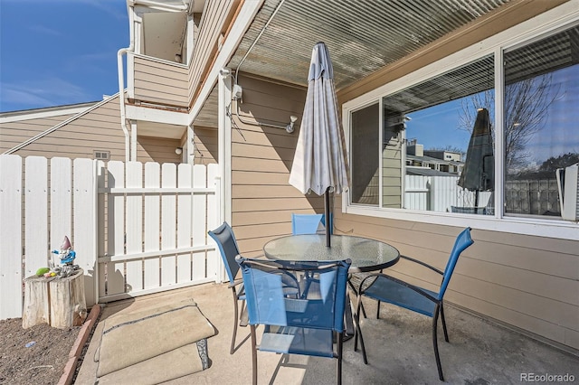 view of patio featuring fence and outdoor dining area