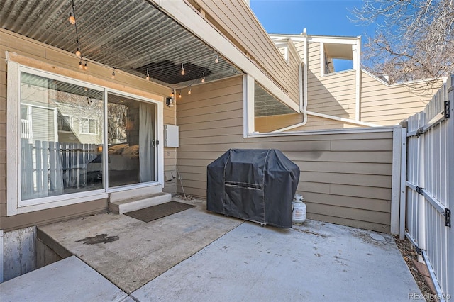 view of patio / terrace with grilling area and fence