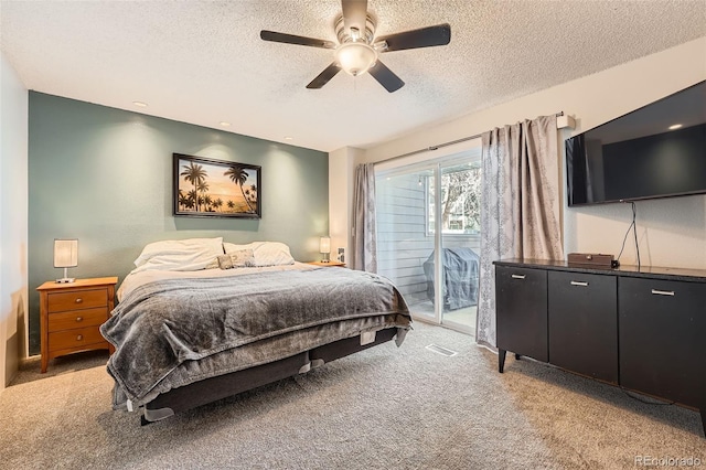 bedroom with a ceiling fan, light colored carpet, a textured ceiling, and access to exterior