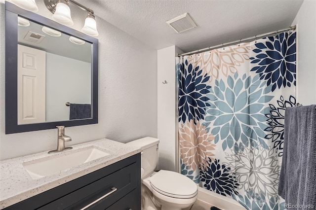 full bathroom with vanity, toilet, a textured ceiling, and visible vents