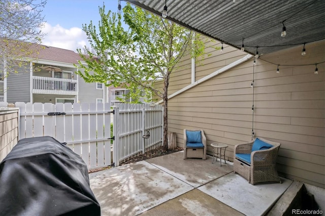 view of patio / terrace with fence and a grill