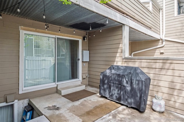 view of exterior entry featuring a patio
