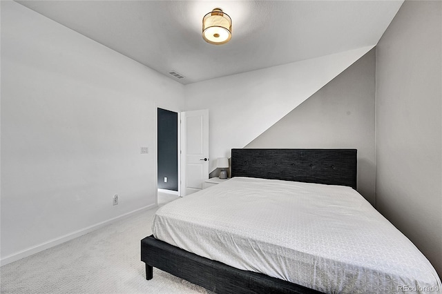 carpeted bedroom with visible vents and baseboards