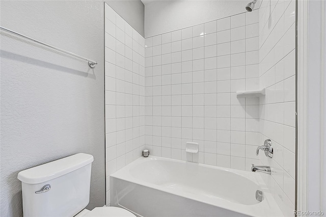 bathroom featuring tub / shower combination and toilet