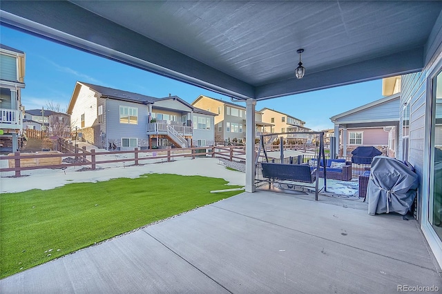 view of patio featuring a grill and a residential view