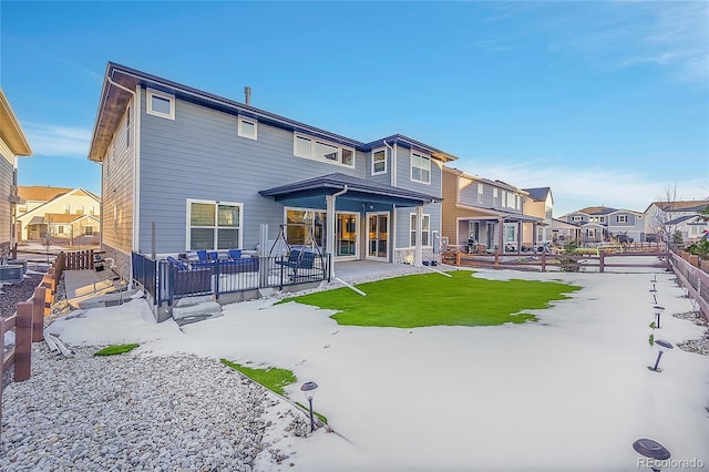 rear view of property with a lawn, a patio area, and a residential view