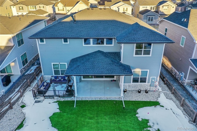 back of house featuring a residential view, a fenced backyard, a yard, and roof with shingles