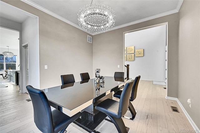 office space with crown molding, light wood-style floors, visible vents, and a notable chandelier