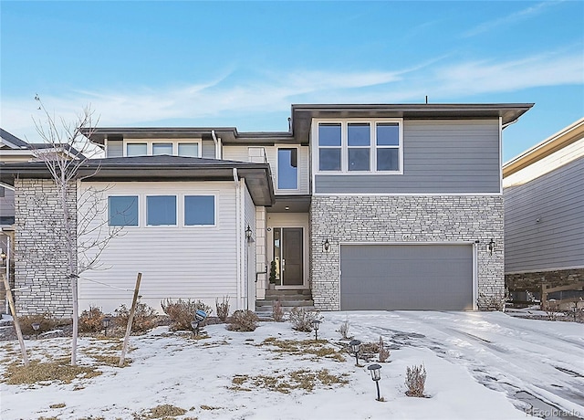 prairie-style house with an attached garage and stone siding