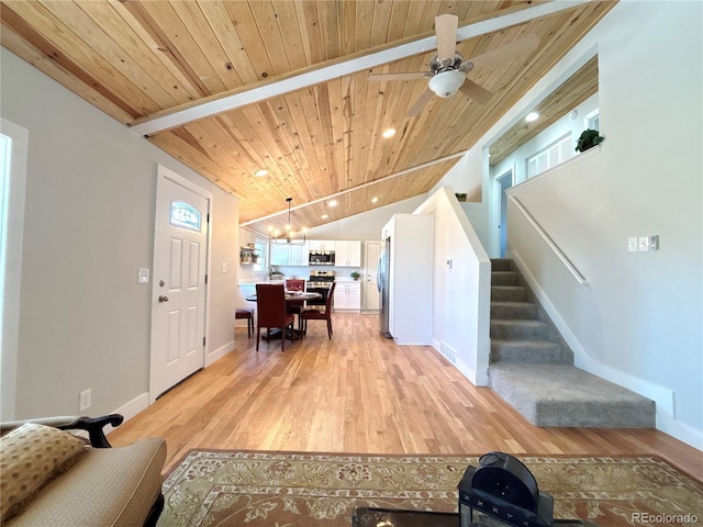 living room featuring wood ceiling, ceiling fan, lofted ceiling with beams, and light wood-type flooring