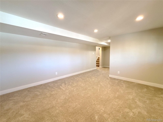 basement featuring light colored carpet