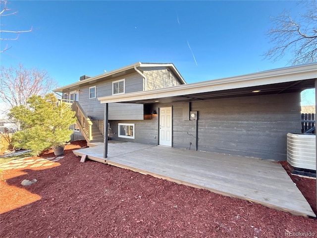 back of house featuring a wooden deck and central AC