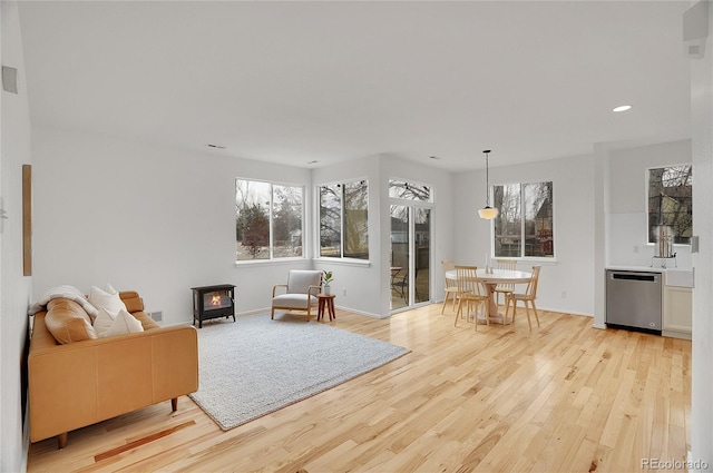 sitting room featuring light wood-type flooring, baseboards, and recessed lighting