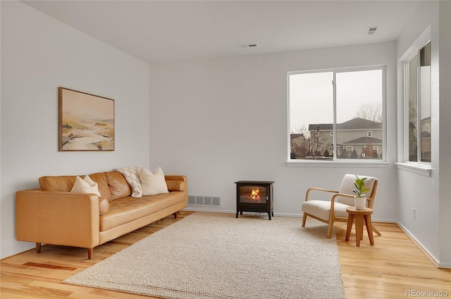 sitting room featuring light wood-type flooring, baseboards, and visible vents