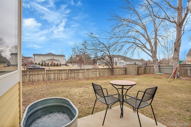 view of yard with a patio, an outdoor structure, and a fenced backyard